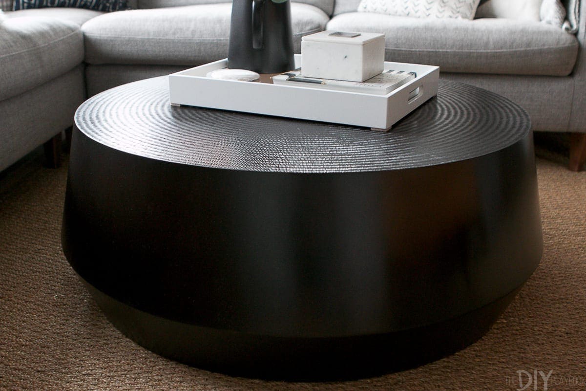 The black round coffee table from Crate and Barrel is the perfect choice for this living room makeover. 