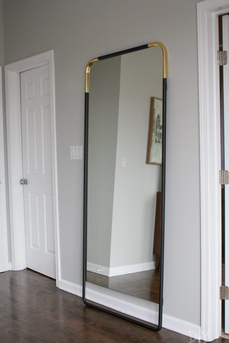 How to secure a leaning mirror to a wall to ensure that it doesn't fall or slide down.