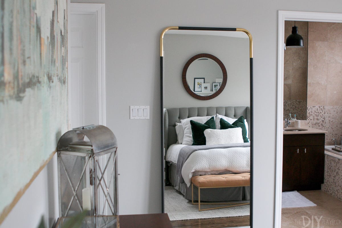 CB2 gold and black full-length mirror in the bedroom.