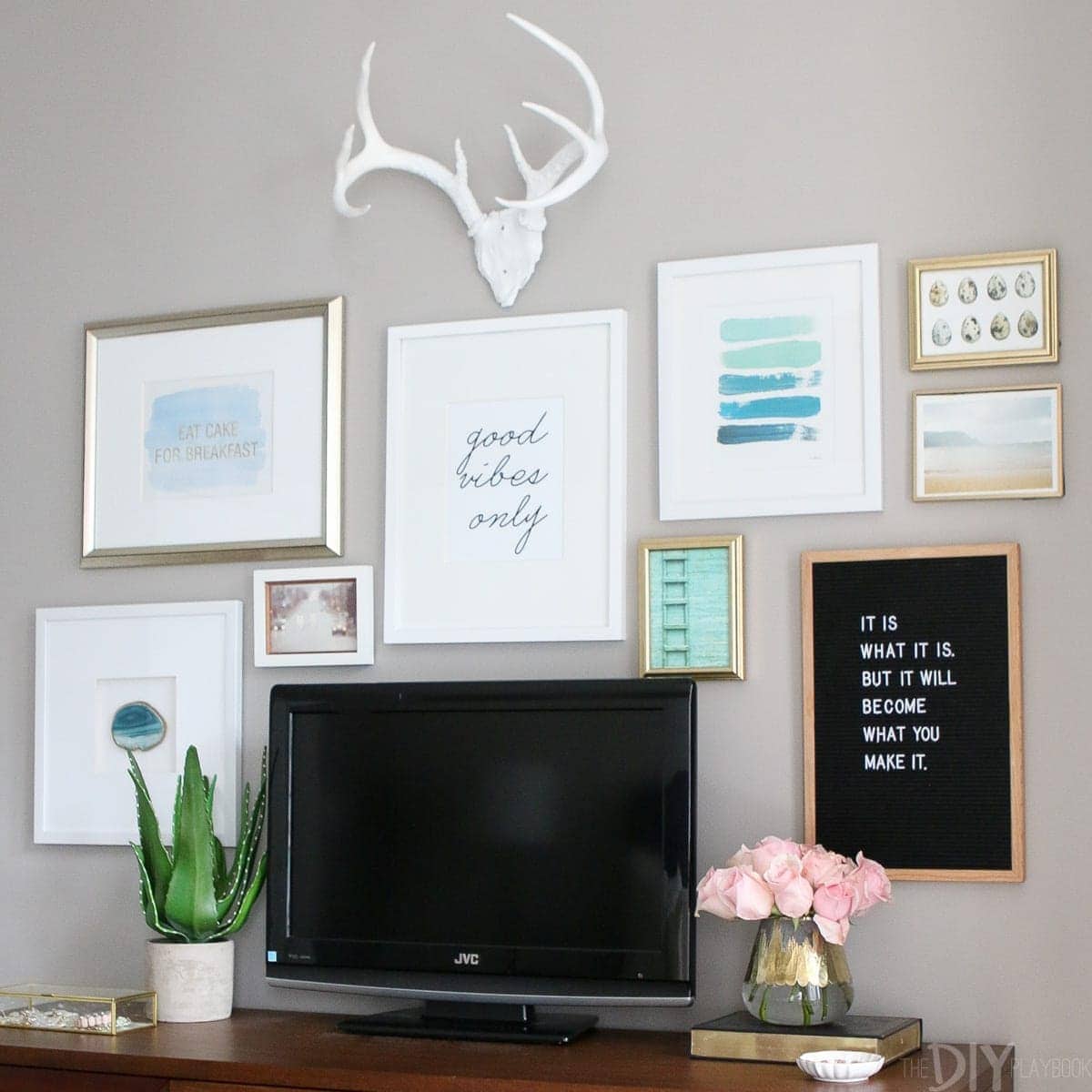 Gallery wall surrounding a television in the bedroom