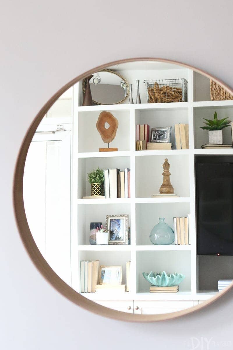 This wall mounted mirror makes the space feel spacious. 