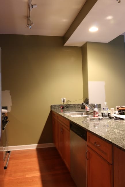 Maggie's kitchen before the makeover. The layout is great, but the weird green wall color definitely has to go. 