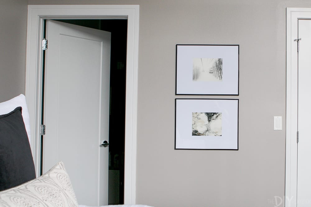 The frames with the think black borders compliment the bedding. 