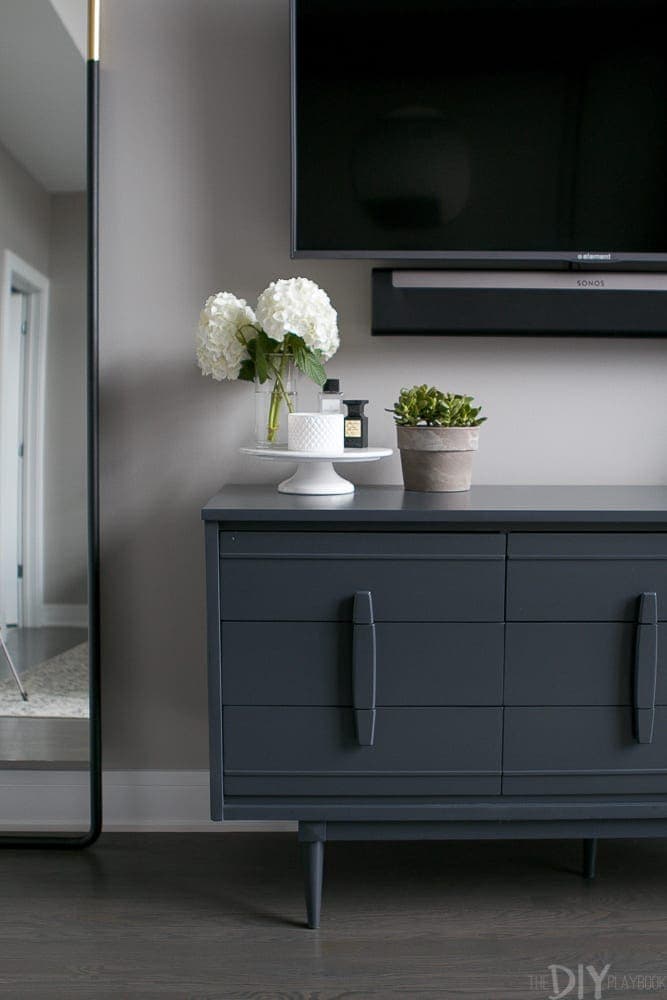 The gray dresser is full of storage space. 