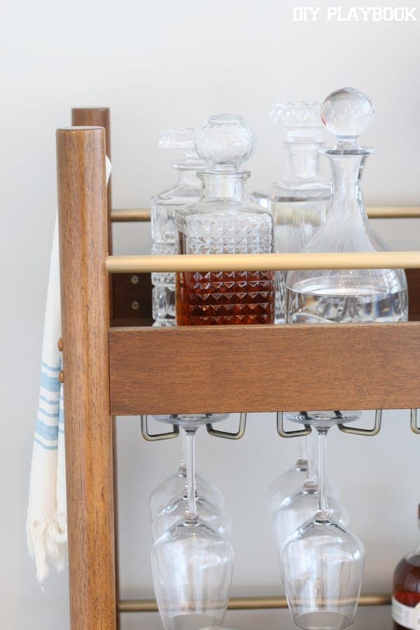 These glass decanters on the bar cart add elegance. 