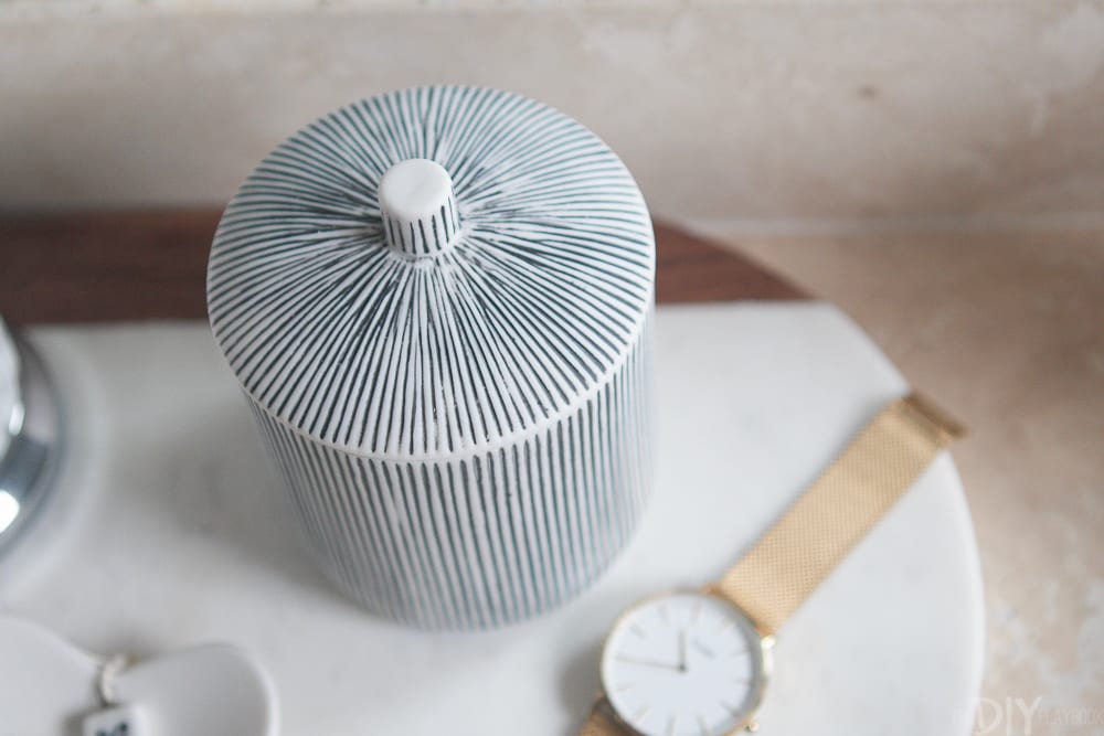 This black and white clay pot is the perfect thing to hold random bathroom items like cotton balls and q-tips. 