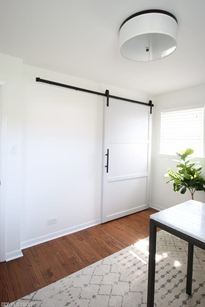 Adjust the rails: How to Hang a Barn Door in your Home DIY | DIY Playbook