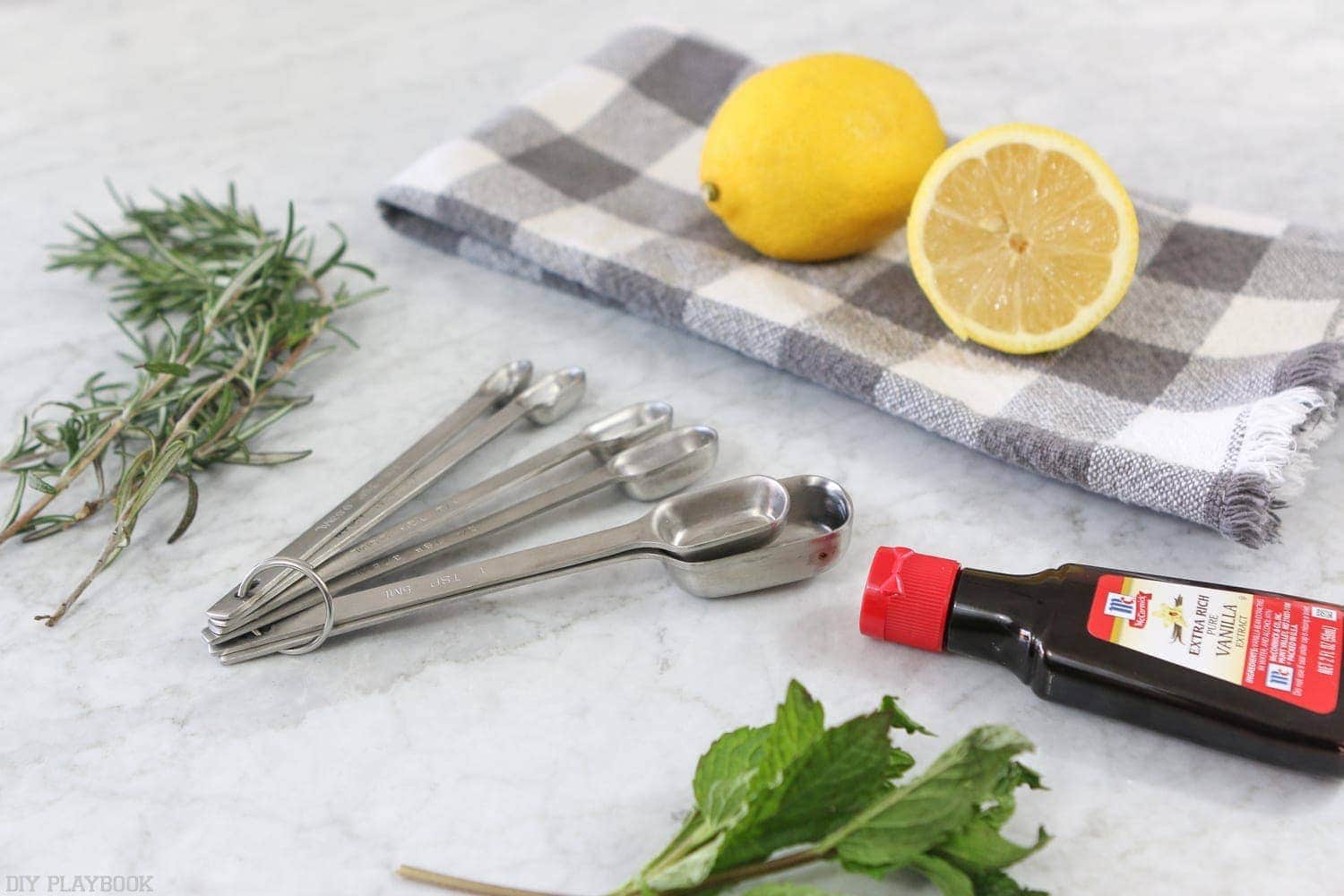 Assemble everything you will need: lemons, rosemary, mint, vanilla and measuring spoons. 