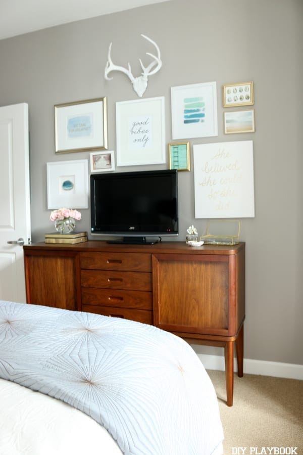 We put a gallery wall up in Maggie's bedroom above the mid century modern buffet. Doesn't it look great agains the neutral gray wall? 