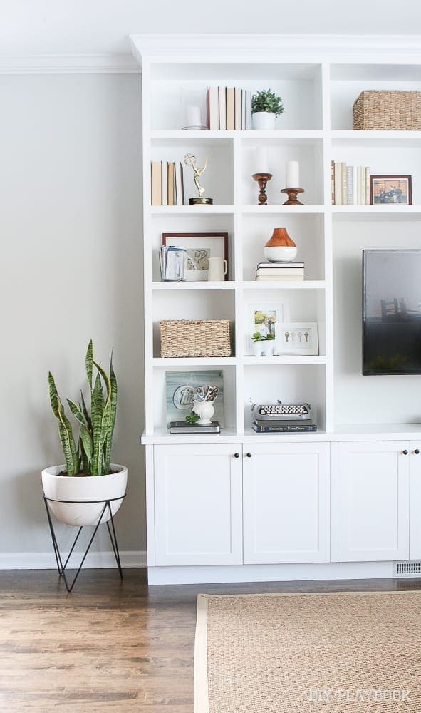 Built-in bookshelf and entertainment center with home accessories. 