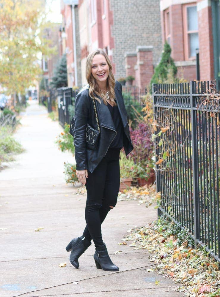 Casey in black booties, black jeans and top, black leather jacket, black purse and her favorite sparkly statement necklace. 