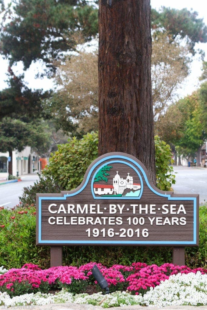 Town sign for Carmel-by-the-Sea, celebrating 100 years. 