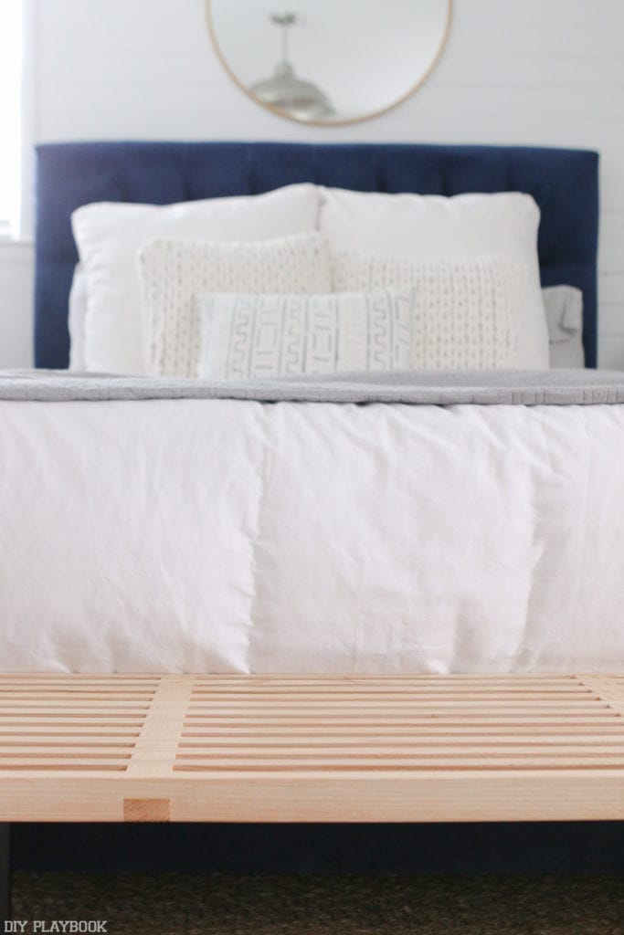 Natural colored MCM style bench at the foot of a bed. 