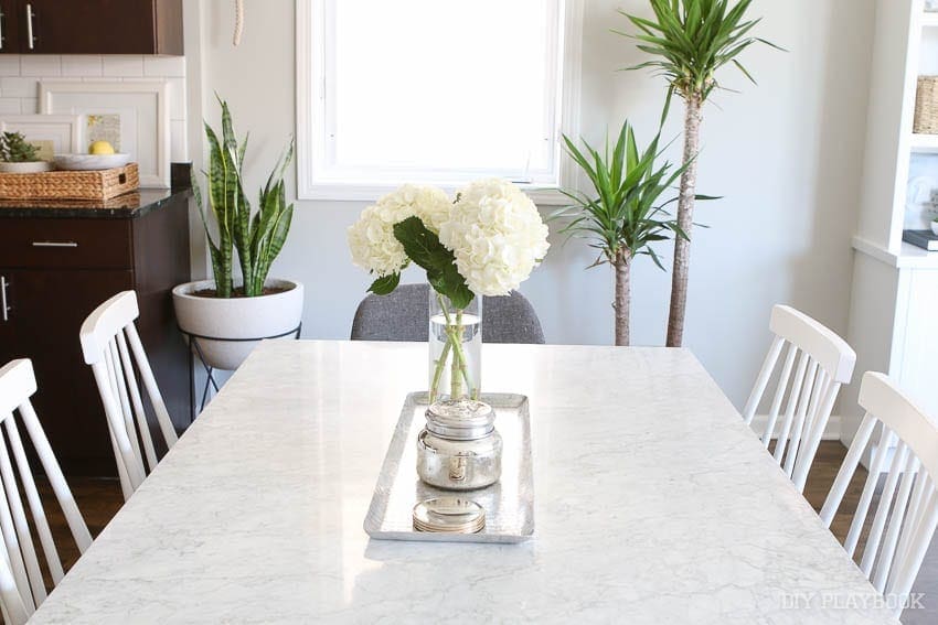 crate and barrel dining room table with white hydrangeas