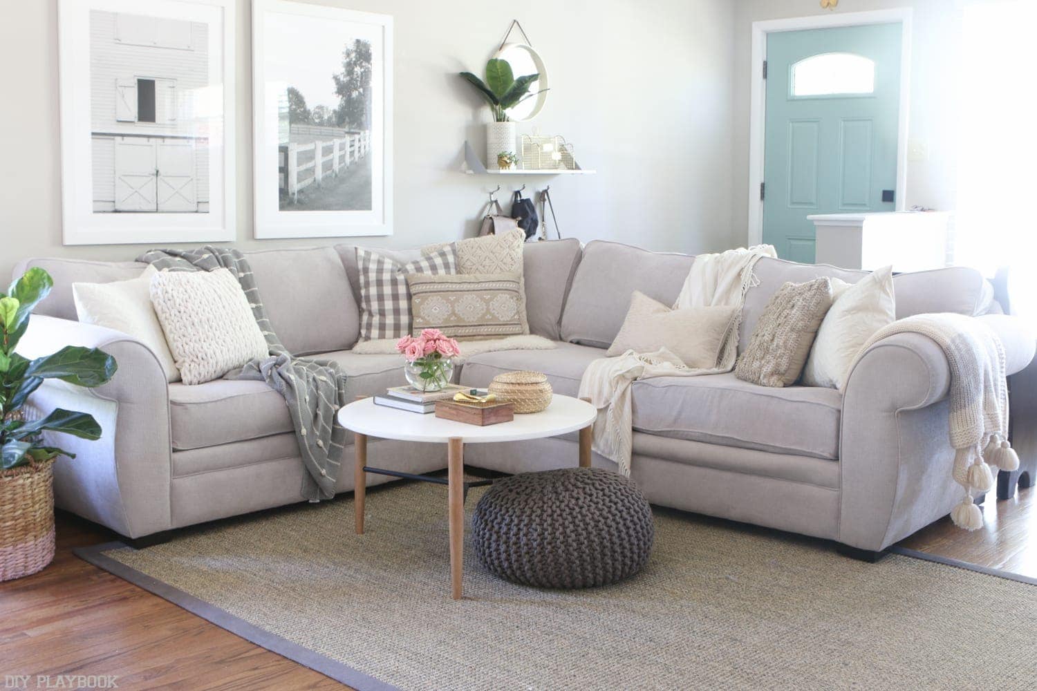 Here's an updated photo of our living room. I love how the sectional sofa works with the other accents in the room, like our round coffee table and our black and white wall art. 