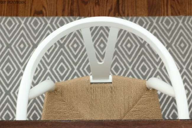 Overhead picture of dining room chairs with woven seats. 