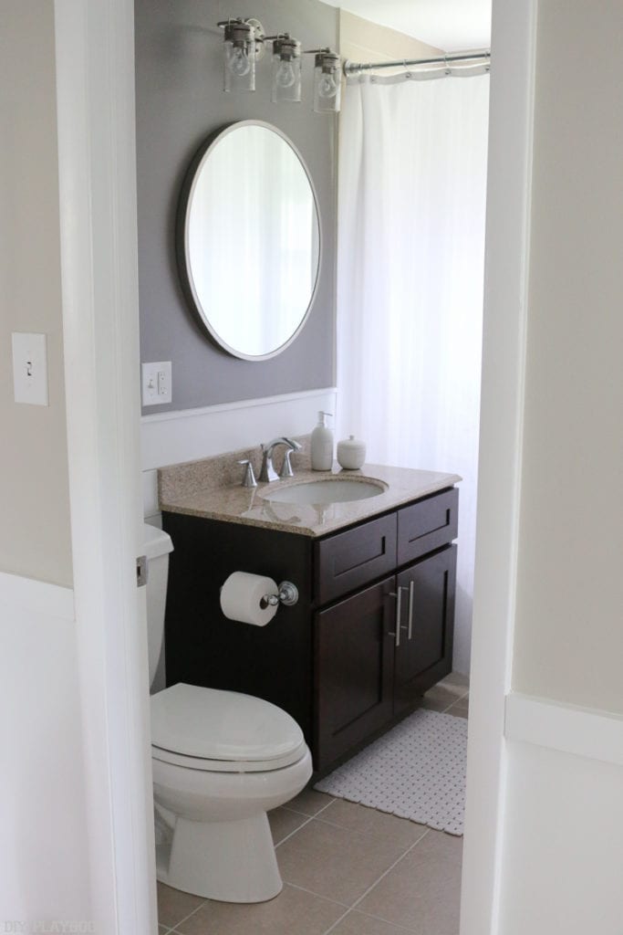 Bathroom with bold grey above the vanity and shiplap update. 