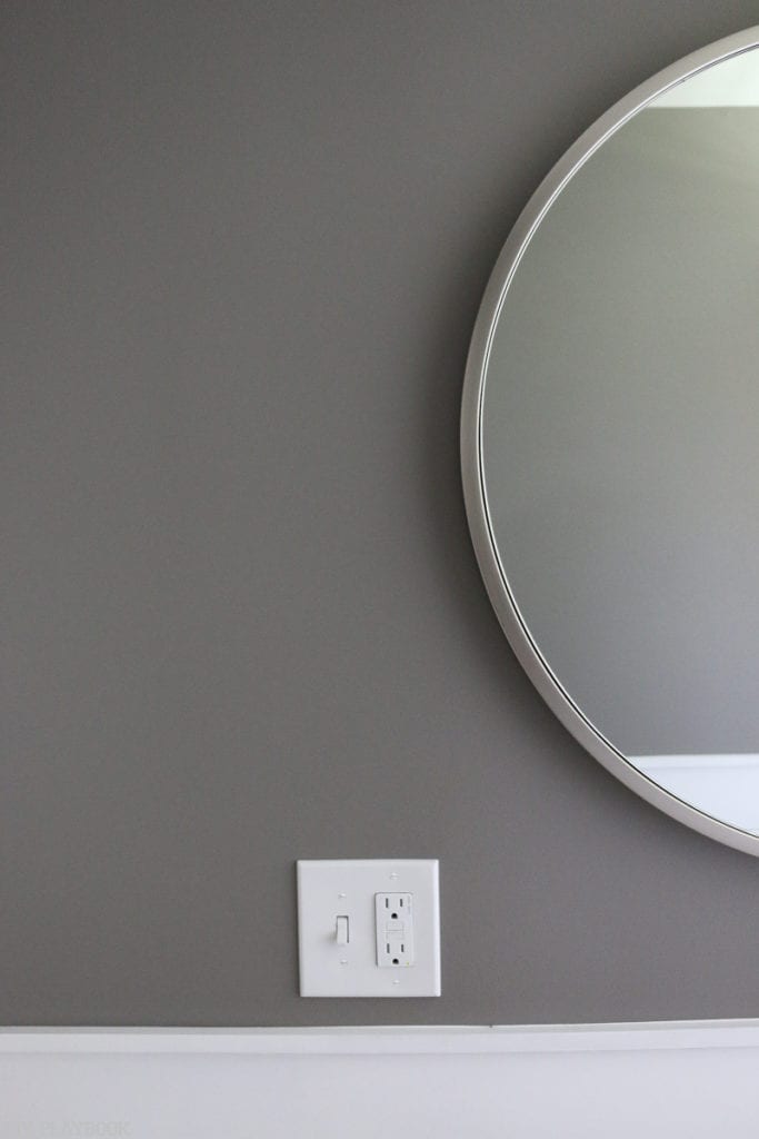 Bathroom with grey paint above the vanity. 