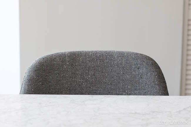 Detail shot of the grey chairs with a round back. 