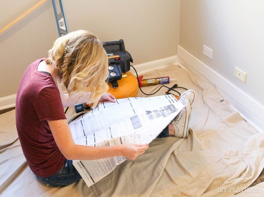 Bridget trying to figure out the inner workings of a nail gun