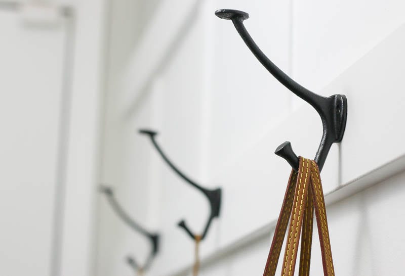 Hooks installed on our board and batten hallway to hang up everything neatly. 