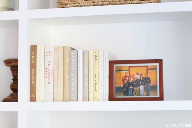 Pair photo frames with books to break up your displays