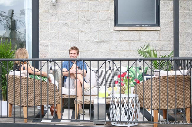 Finn & Casey on their balcony among the new patio furniture.