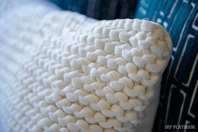 The knitting on this white lumbar pillow is beautiful. 