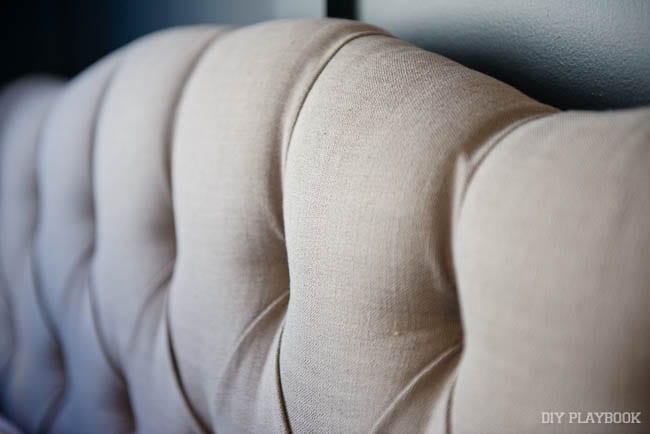 The neutral color of this headboard is elegant. 