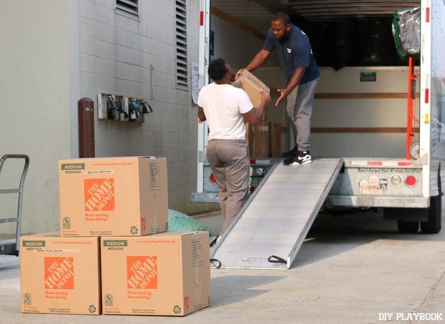 Movers work together to load up the truck with boxes.