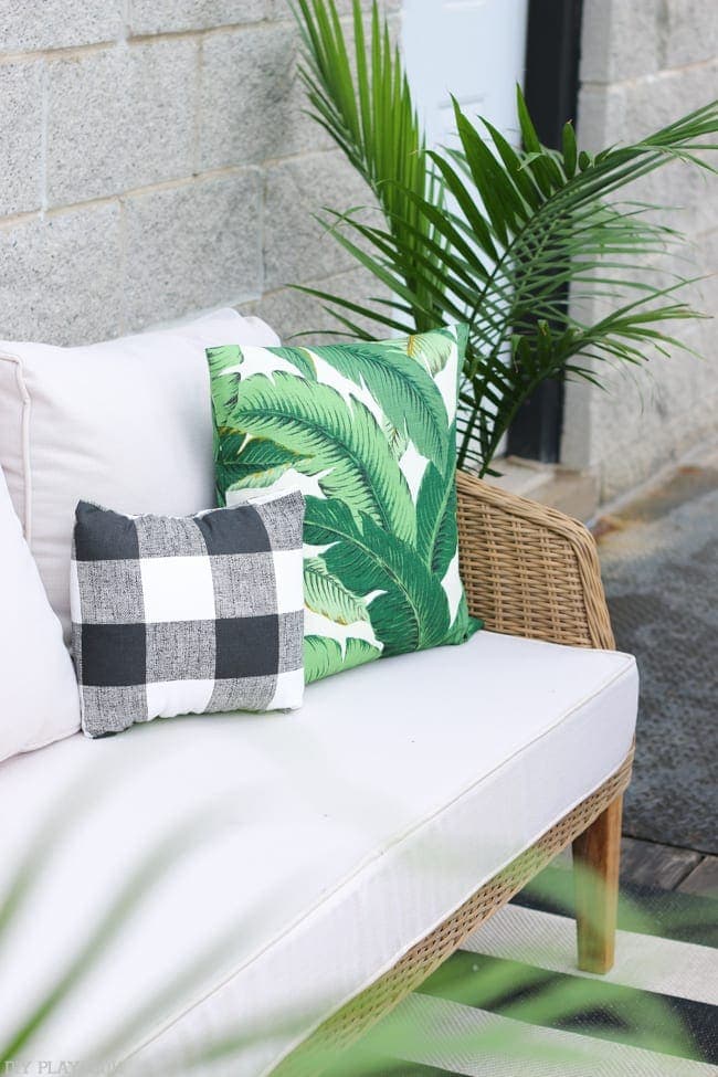 The classic look of the rug let us mix and match patterns more freely, like these palm frond and buffalo check pillows!