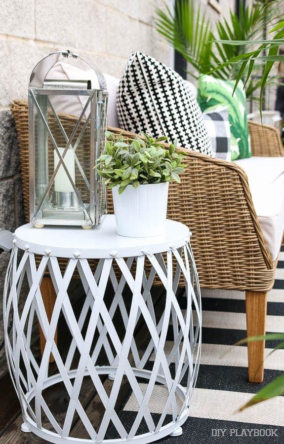 This amazing white garden stool from Home Goods is so versatile - I love the way it looks as a side table.