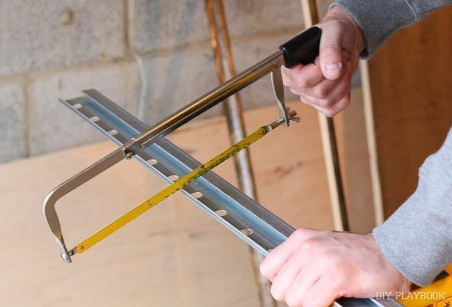 Use a handsaw to cut through your Ikea rails