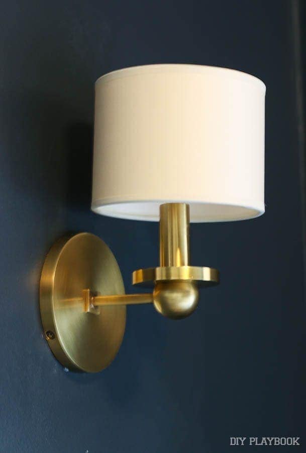 One of two gorgeous gold and white wall sconces. They go together above the credenza we're building!