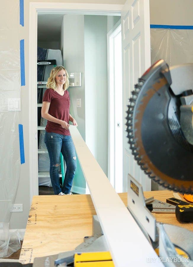 Bridget cutting wood with the miter saw for the project. 