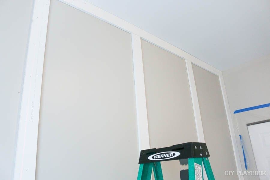 Installing vertical boards in the guest bedroom makeover. 