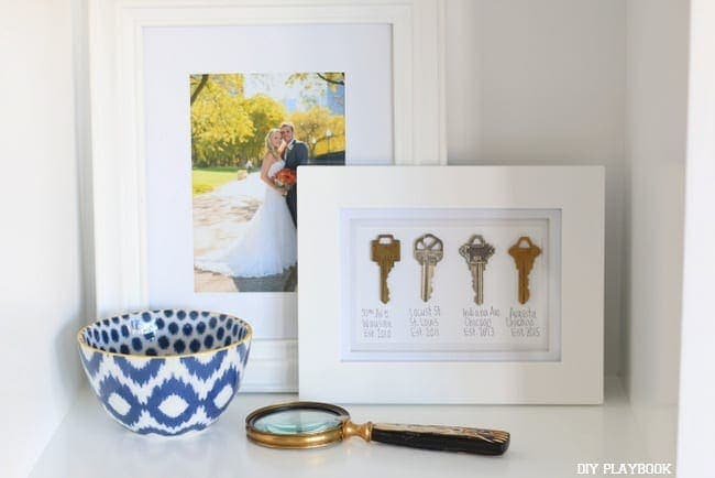 This shelf got a photo from our wedding day, our DIY key art and some pottery. 