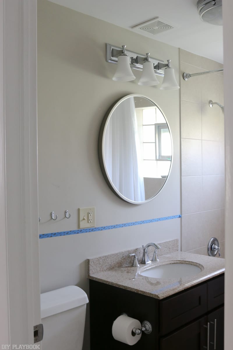 Bathroom before paint and light fixture makeover.