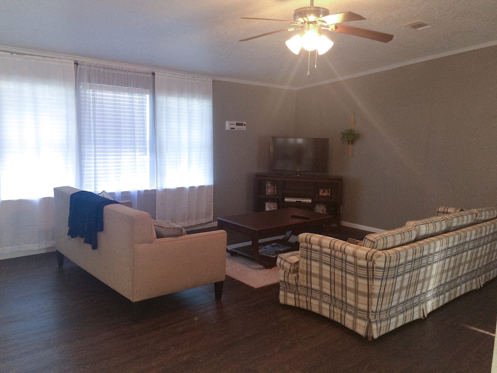 This living room is dark, outdated, and needs some major updates. 