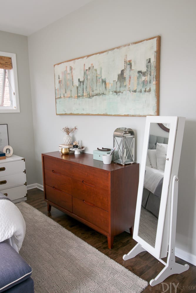 A jewelry stand in a master bedroom to hold lots of jewelry. 