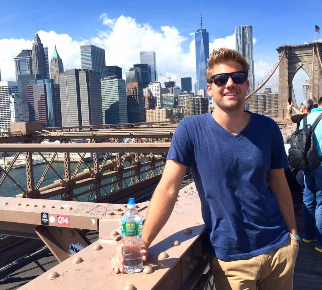 Finn poses on the Brooklyn bridge overlooking the NY skyline