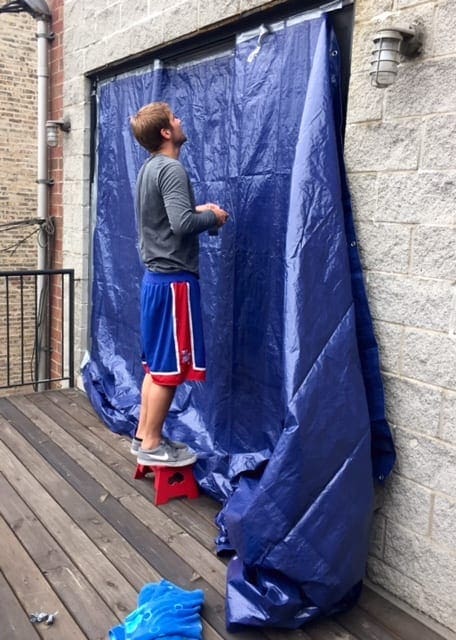 Finn had to cover our glass door with a big, blue tarp to prevent any further water damage to our new stained hardwood floors!