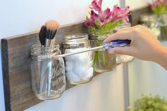 Carefully unscrew the mason jar from the hose clamp with your screwdriver