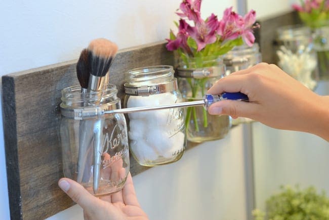 Using a flathead screwdriver, carefully remove the mason jars