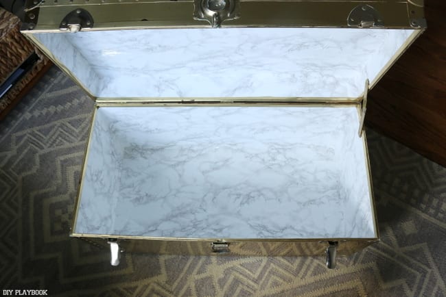 I used our favorite marble contact paper to refinish the inside of the vintage trunk. Good as new!