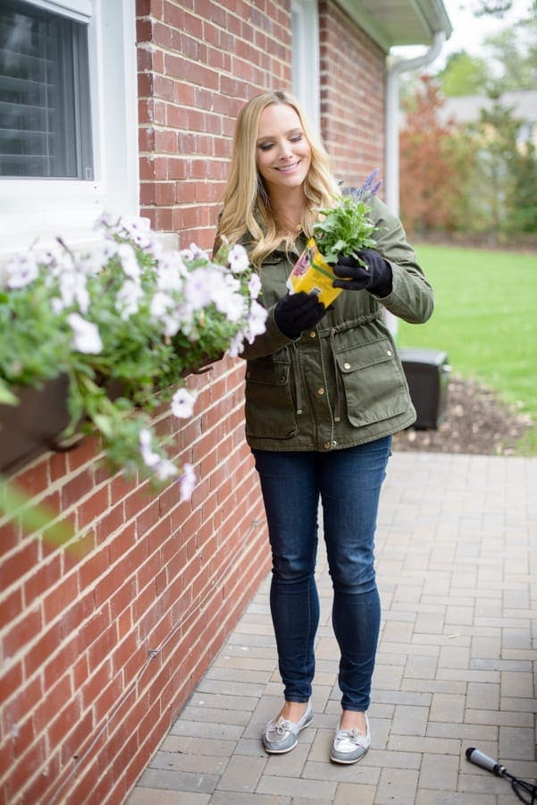 Casey adds fresh flowers to her home's exterior.