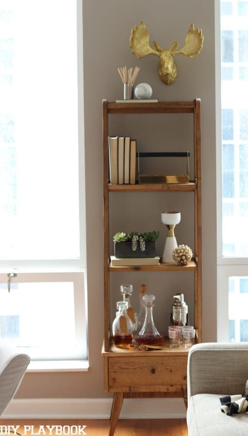 This wooden shelving unit is perfect for a mini bar or for books. 