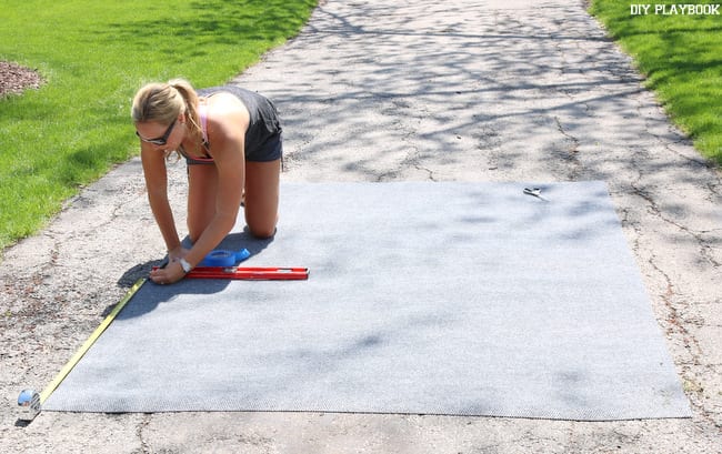 Casey marking up the blank rug, before we got our spray paint on!