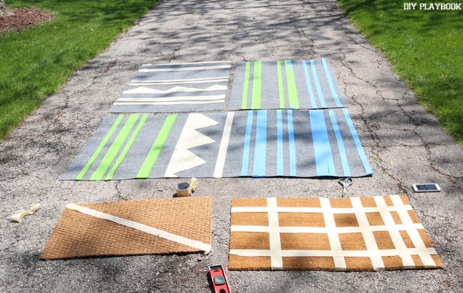 For the second step in creating our DIY outdoor painted rugs, we used painter's tape to make patterns and shapes on the rugs. Next we will apply the spray paint!