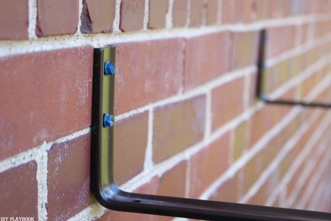 Attach the concrete screws and brackets to the outside brick wall. 